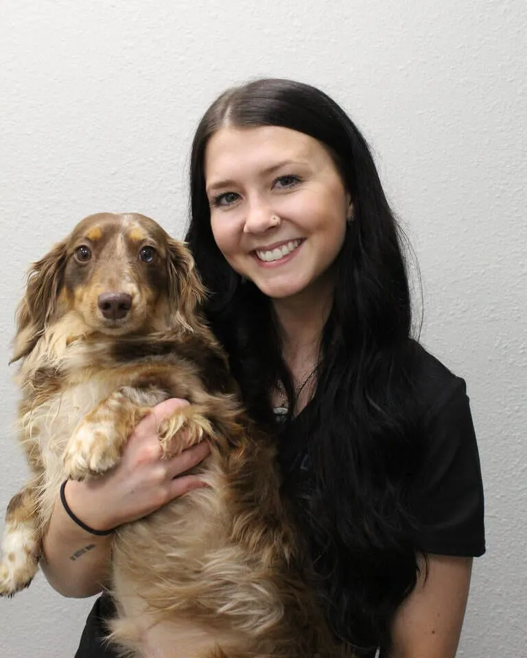 Zaelea Harris holding a long-haired dachshund